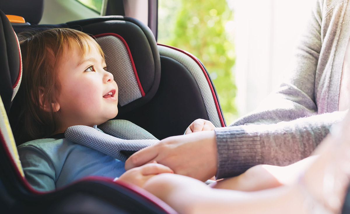 Parent buckles child car seat