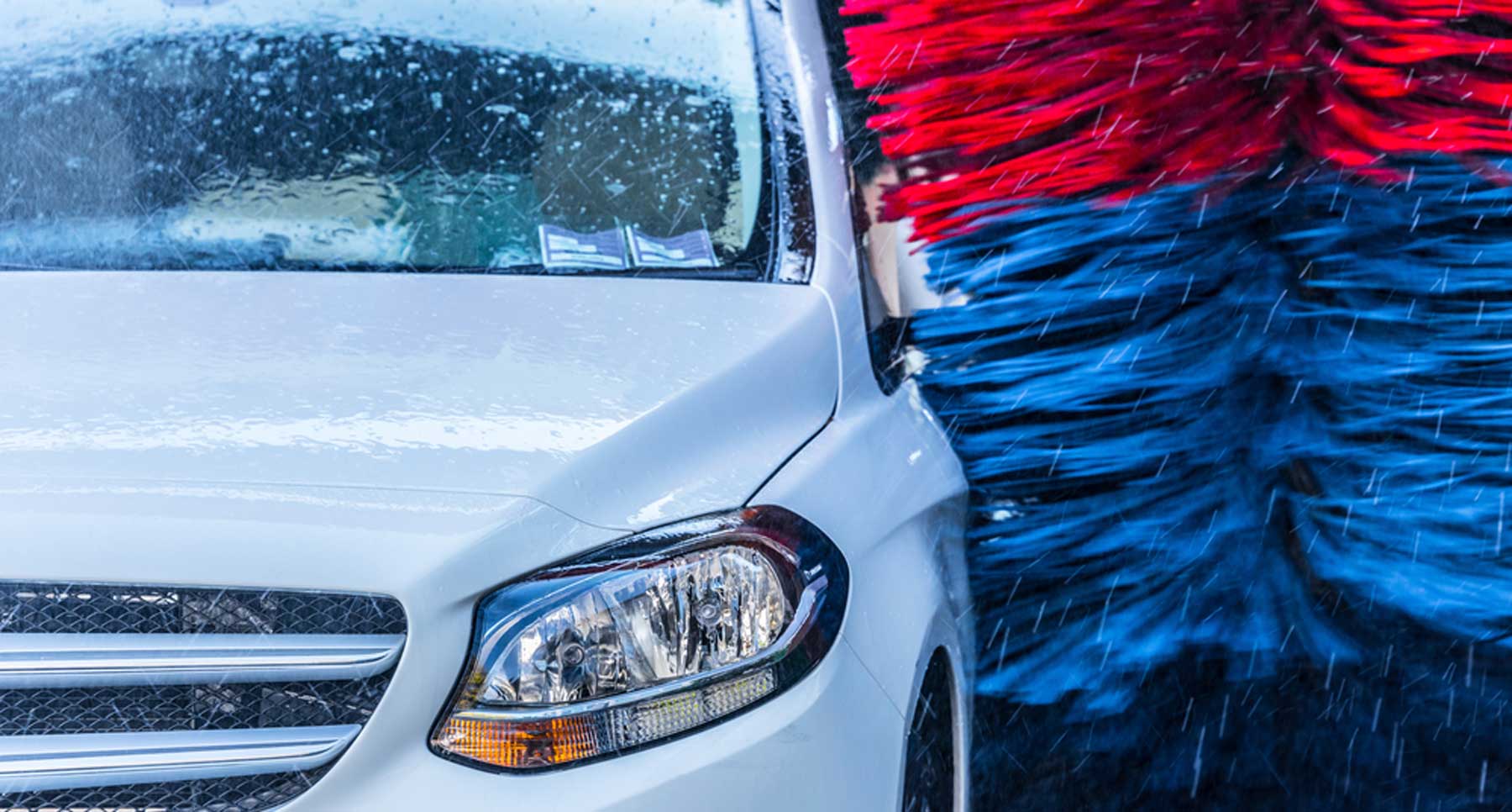 white car inside an automated car wash